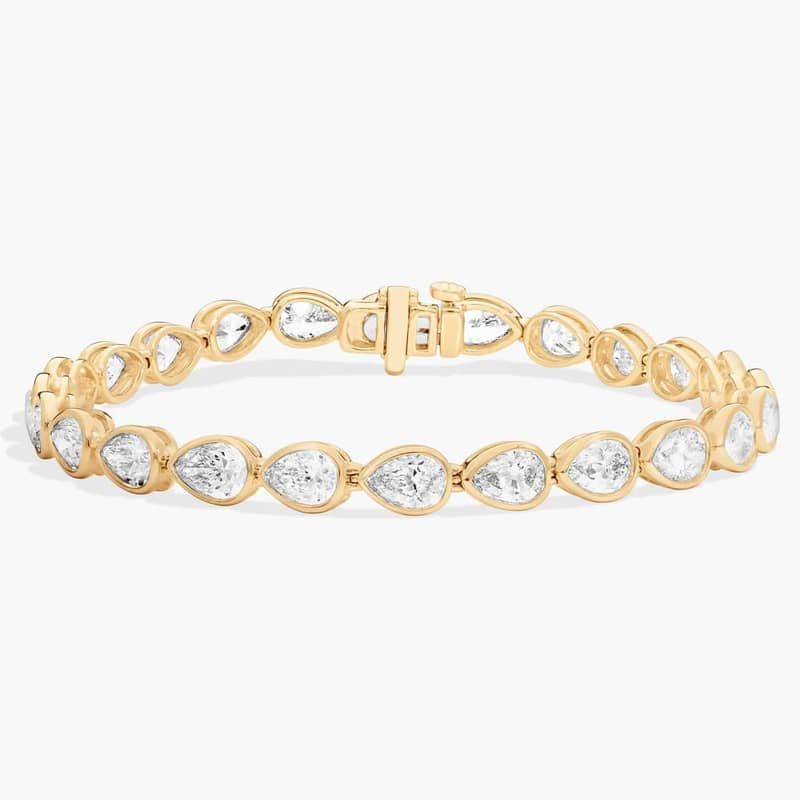 East-West Bezel Tennis Bracelet With 10 CTW Pear Shaped Diamonds in 14K Yellow Gold