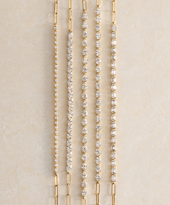 layered mini half-bracelets in yellow gold